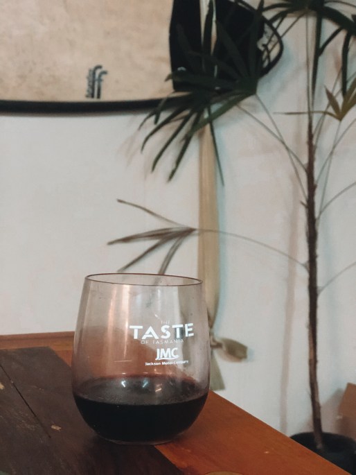 stolen taste of tasmania cup with surfboard and red wine